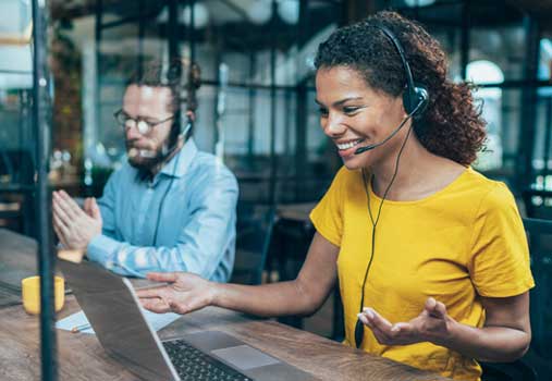 Customer service agents speaking to clients using our provided headsets used with our VOIP service.