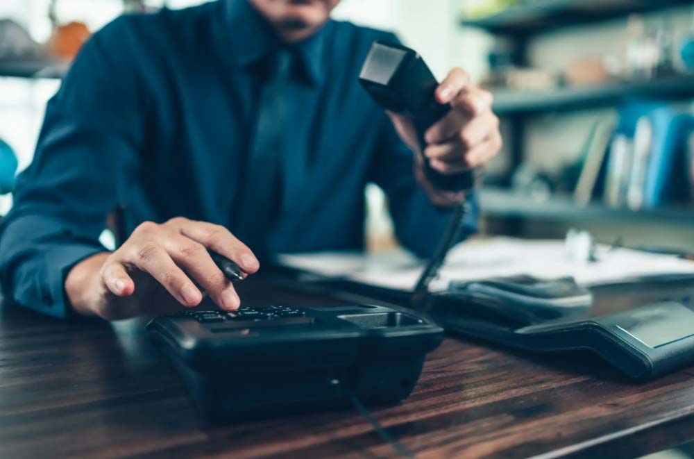 Bussiness owner using one of our provided phone systems.